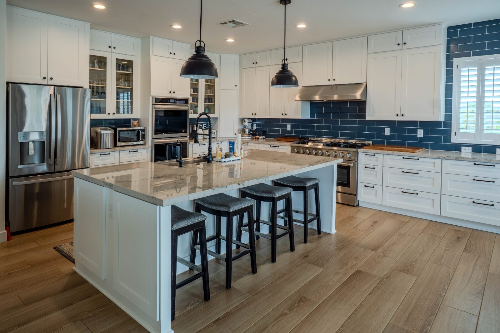 Professional range with blue subway tile backsplash