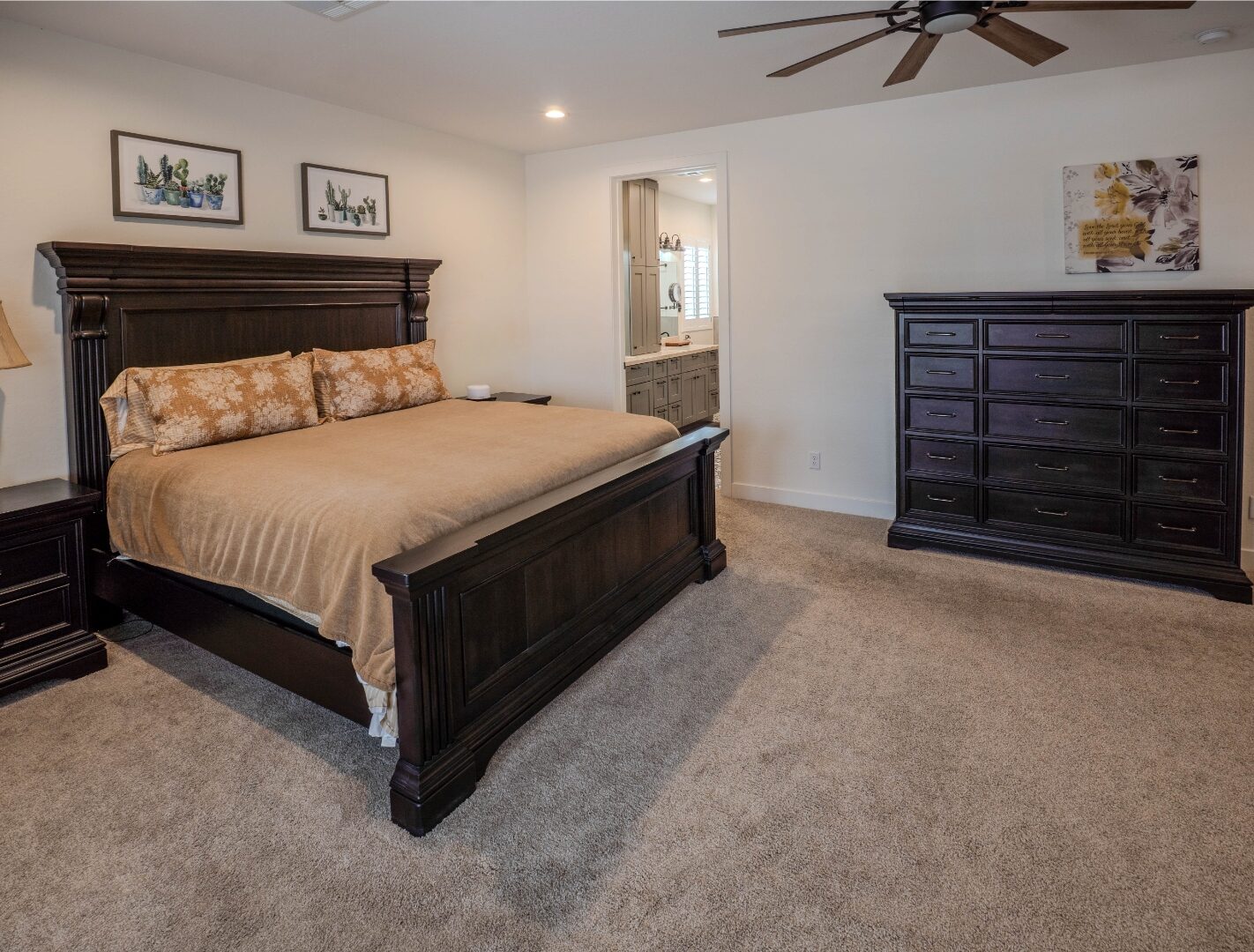 Master bedroom with dark wood furniture and en-suite