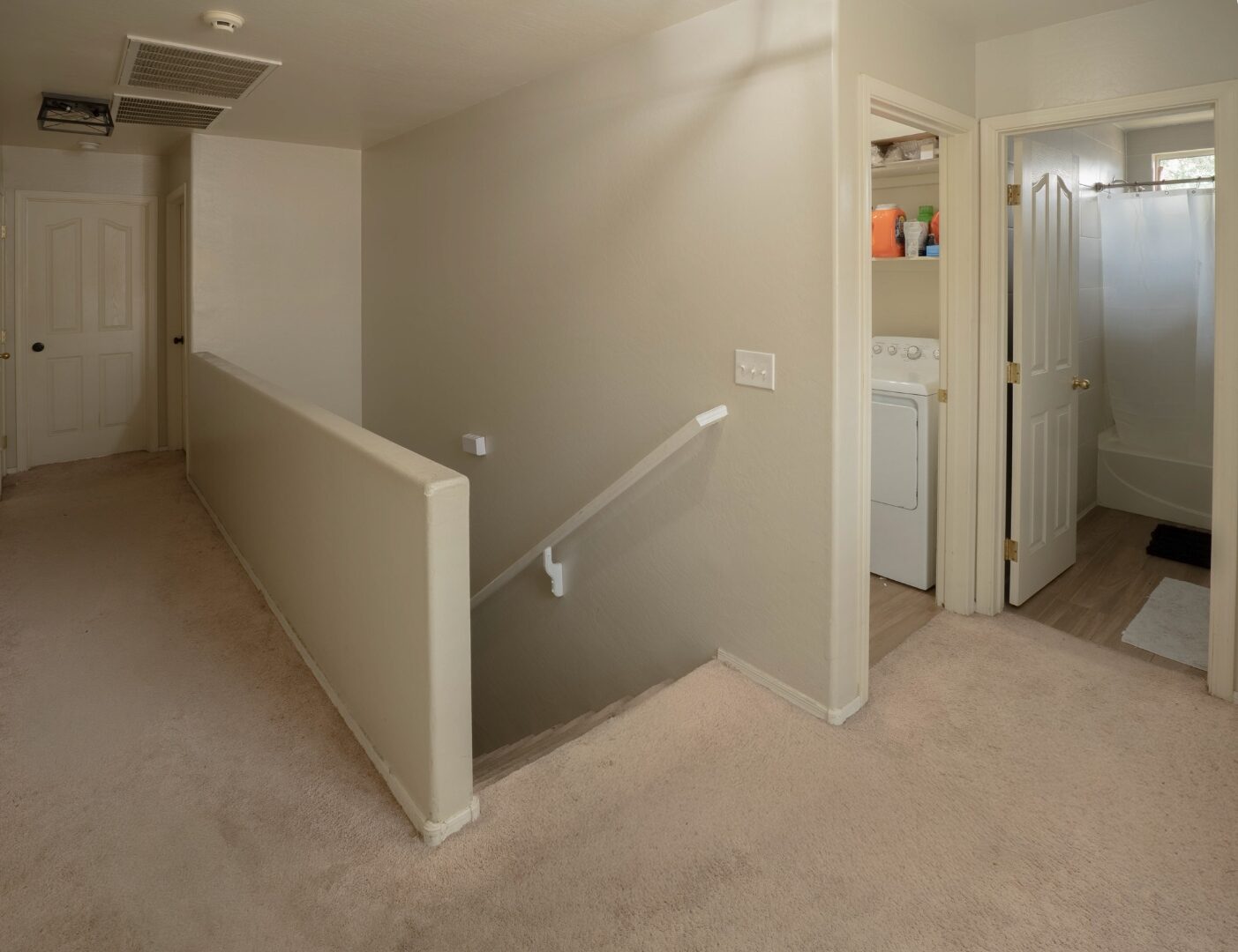Upper landing with staircase and laundry room access